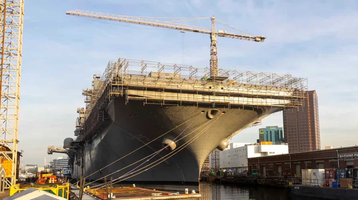 A US Navy warship sits in a dock.