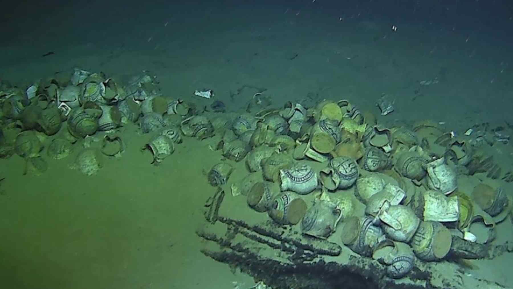Ceramic jugs and plates scattered on the seafloor at the Camarat 4 16th-century shipwreck, over 2,500 meters deep.
