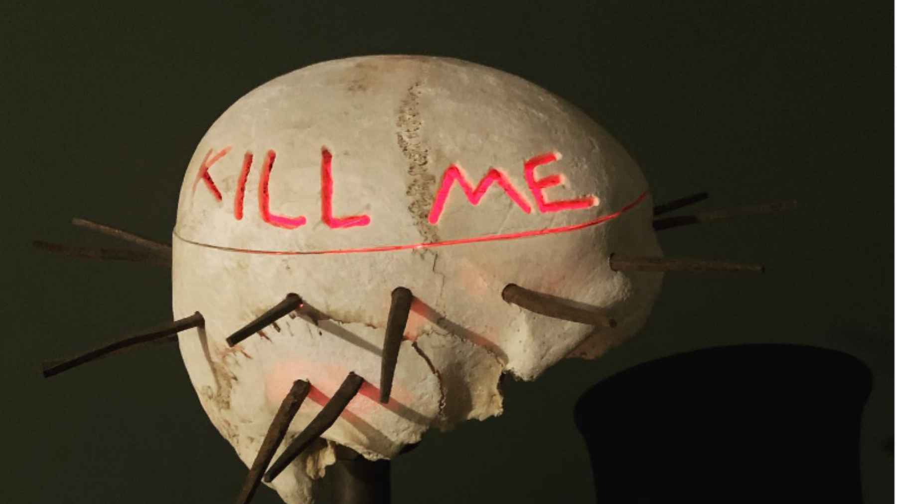 Skull with disturbing message and spikes