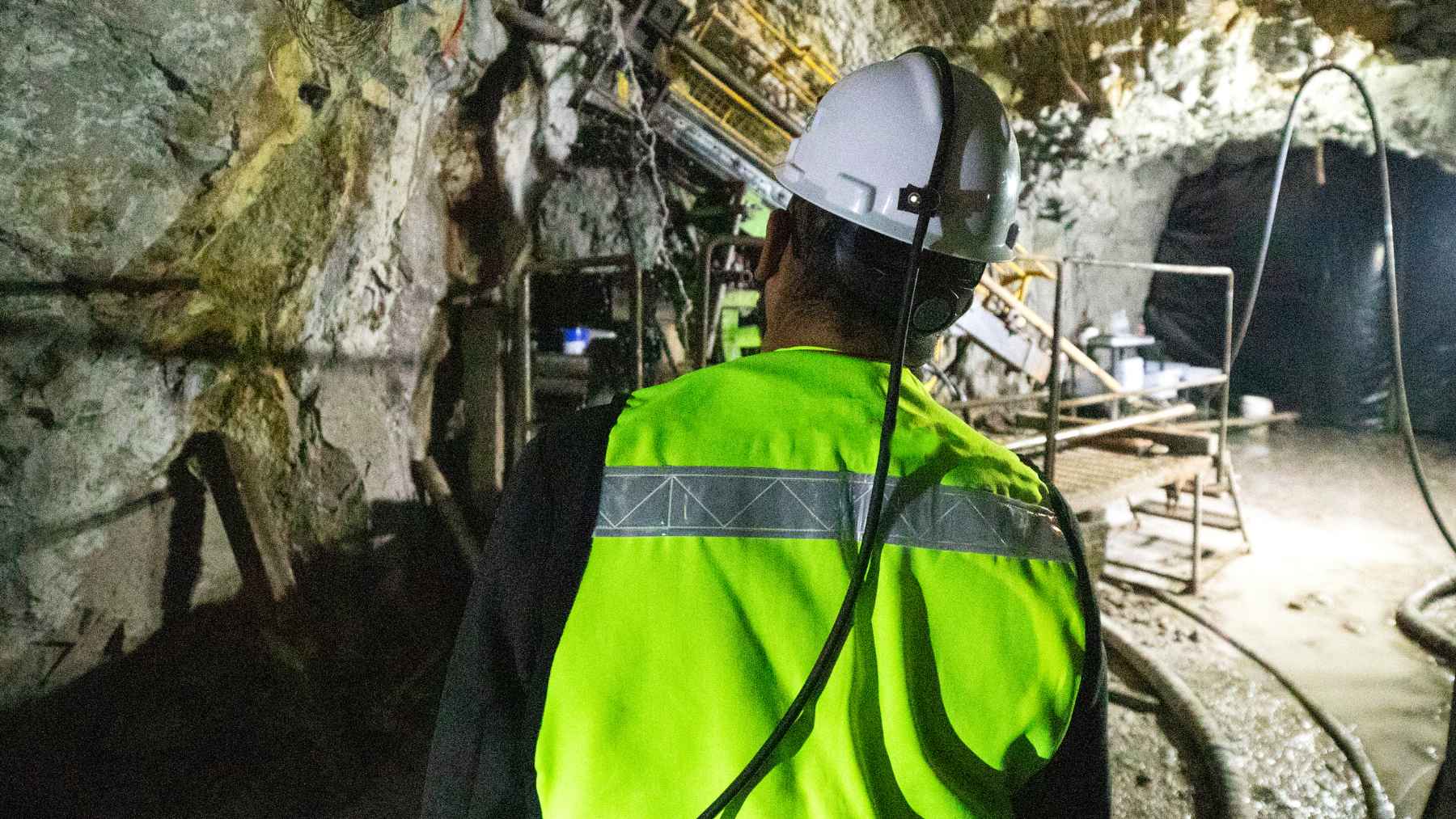 Operario con casco y chaleco reflectante en una mina subterránea, clave para extraer minerales críticos
